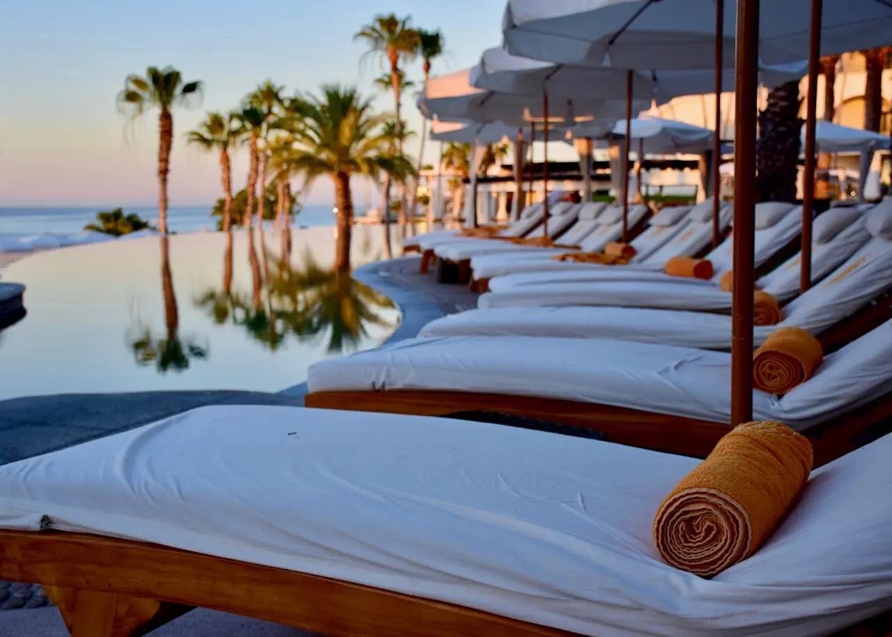 Sun loungers and parasols on a beach club terrace in Estepona with calm blue Mediterranean sea and clear sky