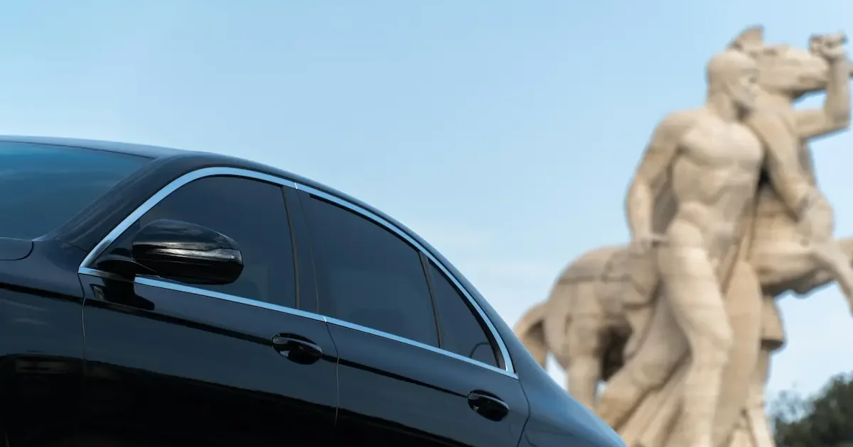 Luxury Mercedes transfer car at Malaga Airport monument.