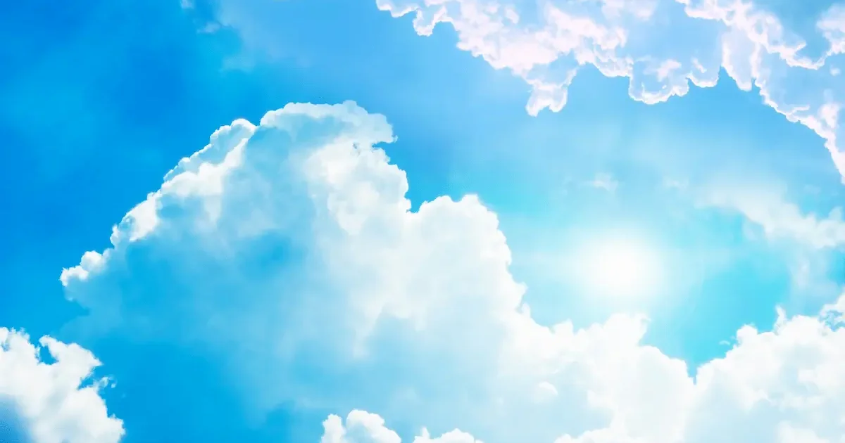 Malaga seafront promenade on a warm April morning, palm trees and clear blue sky, few people walking along the beach.
