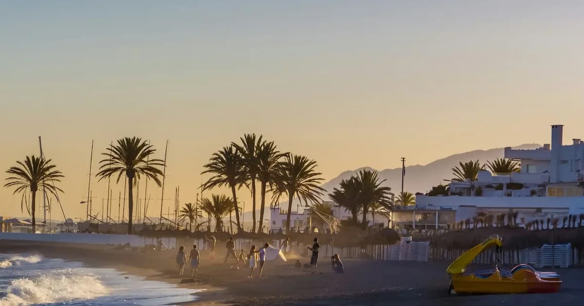 Clear turquoise water at a Blue Flag beach in Marbella with golden sand and La Concha mountain in the background