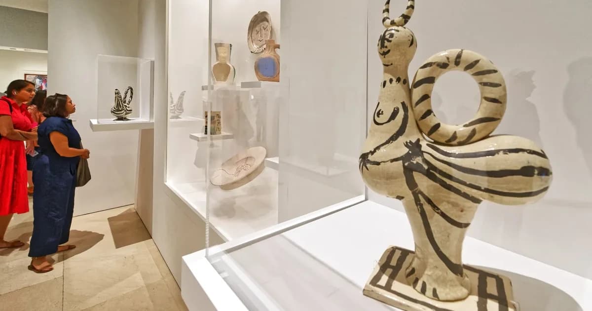Facade of the Museo Picasso Málaga in the Palacio de Buenavista, with stone archway and orange trees in the courtyard.
