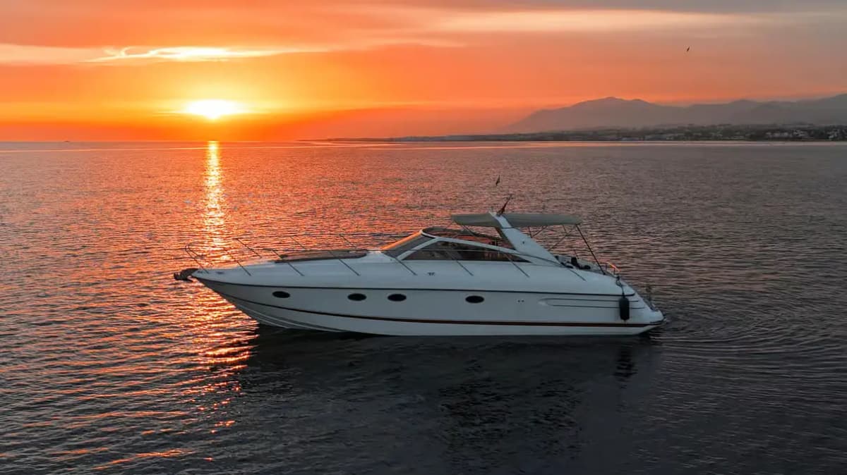 Luxury yachts docked in Puerto Banus marina with white Andalusian buildings and La Concha mountain in the background, Marbella, Spain.