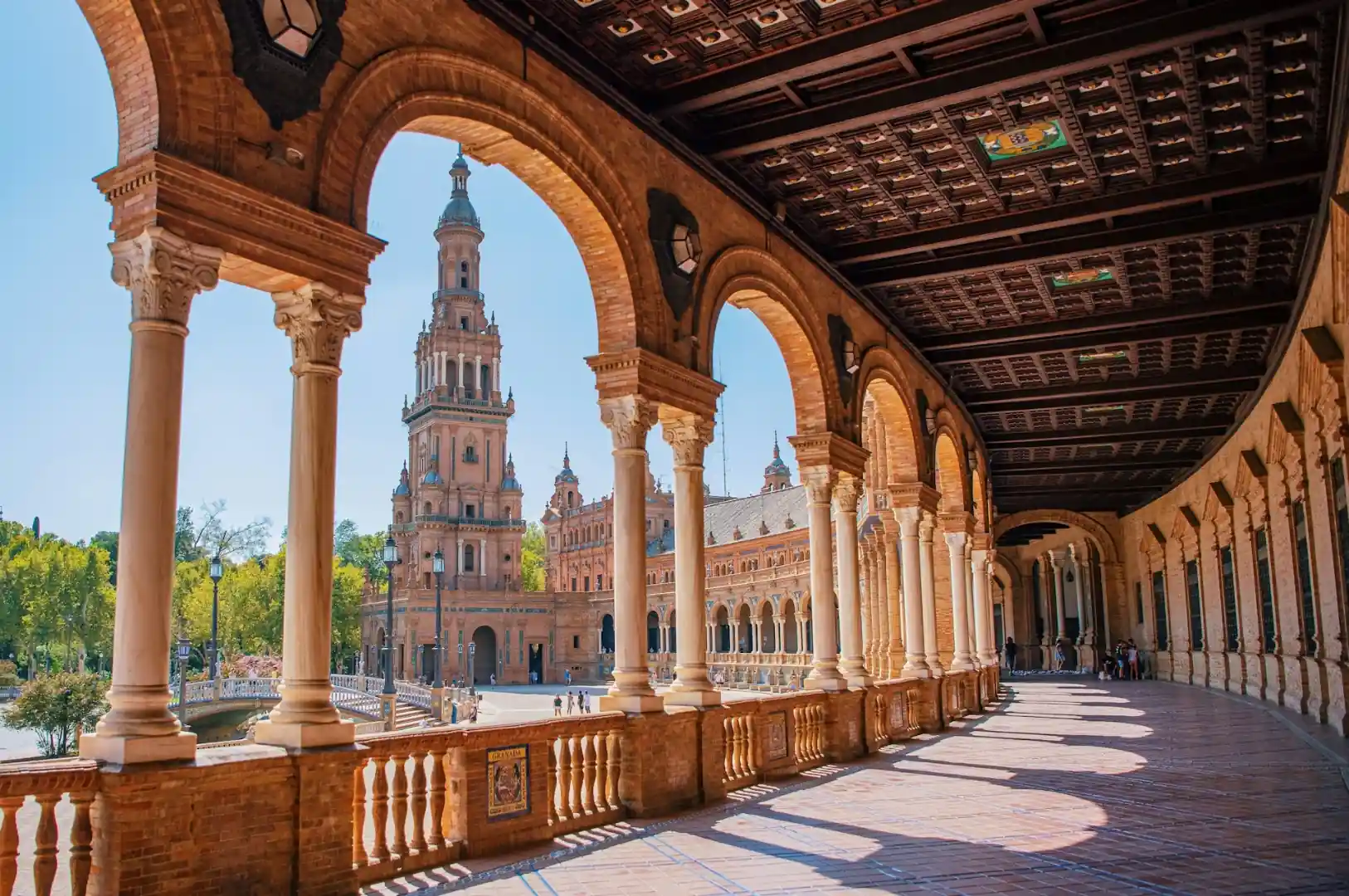 Plaza de Espana Seville with its ornate semicircular building reflected in the canal below