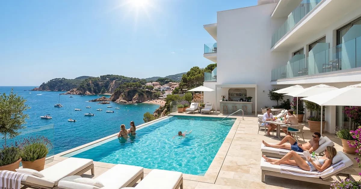 Beachfront hotel rooftop pool Costa Brava with panoramic sea views and sun loungers