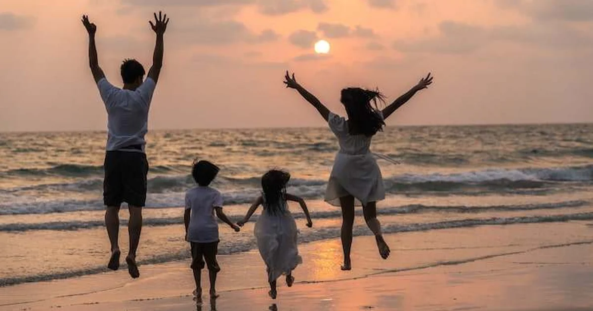 Happy family running with toddler on sunny Spanish beach: perfect for Malaga kids vacation 2026 – sand, sea, joyful family activities.