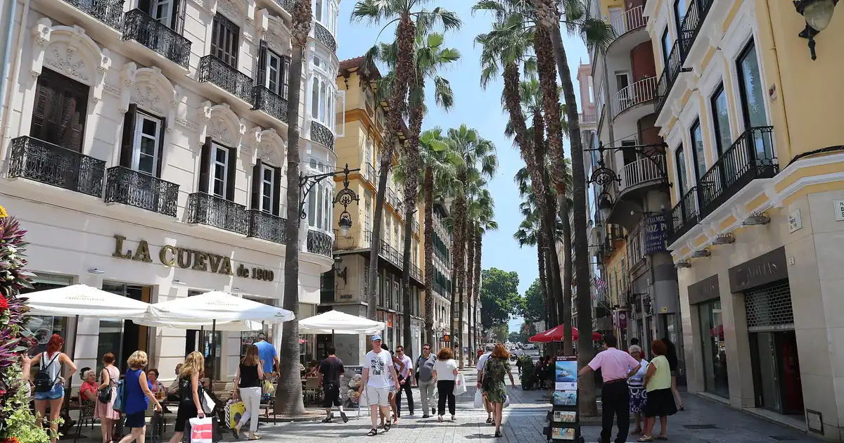 Calle Larios pedestrian street in Malaga Old Town with cathedral visible at the end
