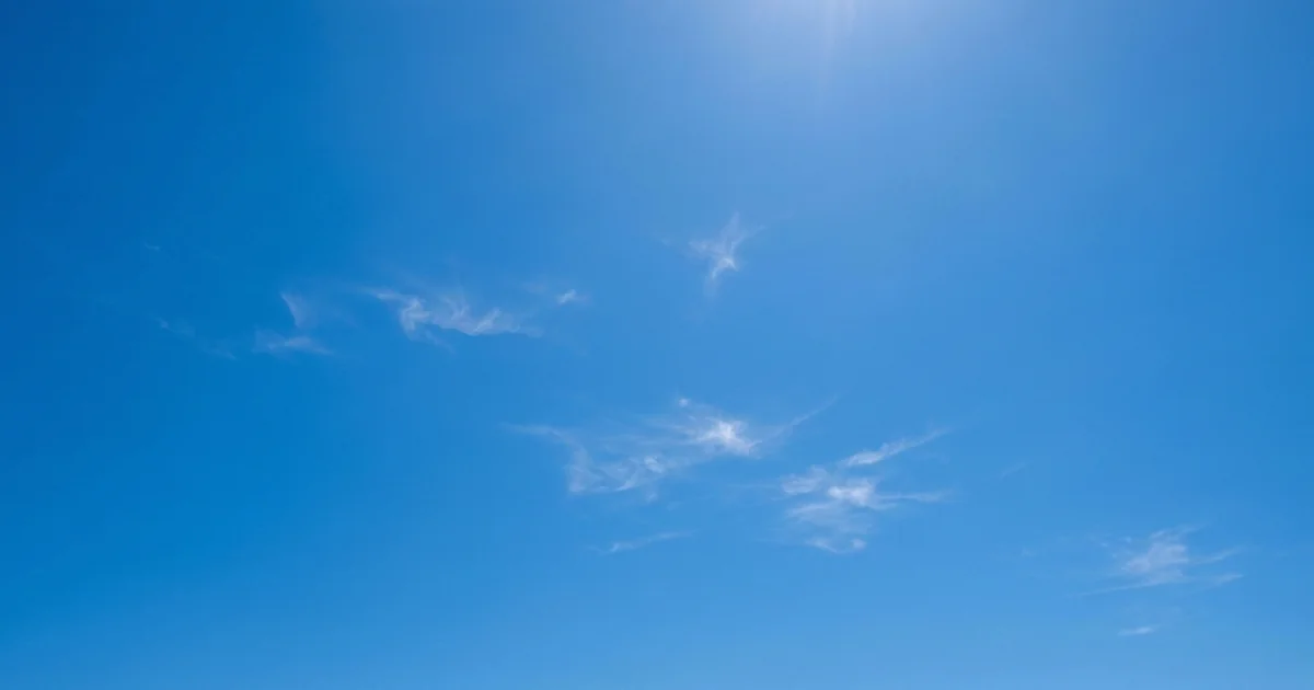 Malaga weather in July with clear bright sunny sky and minimal white clouds, typical hot summer conditions on Costa del Sol