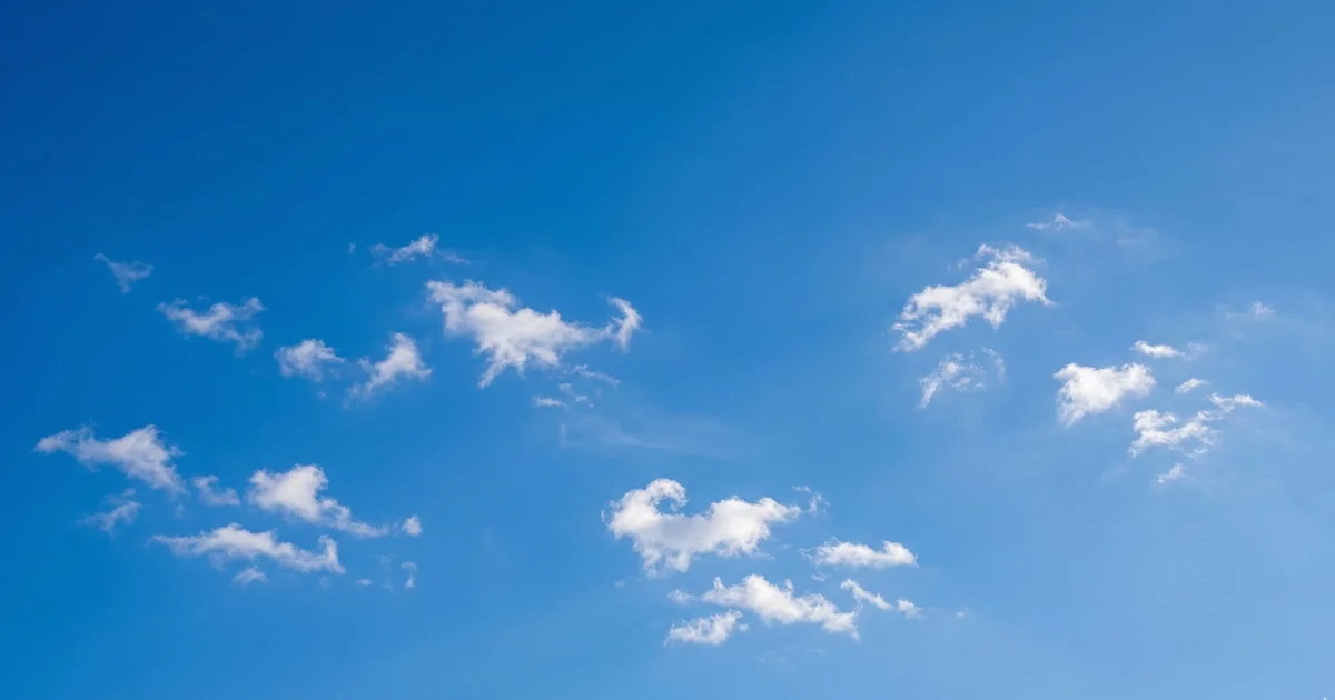 Malaga weather in September with warm early autumn sky, soft scattered white clouds, bright sunny conditions on Costa del Sol