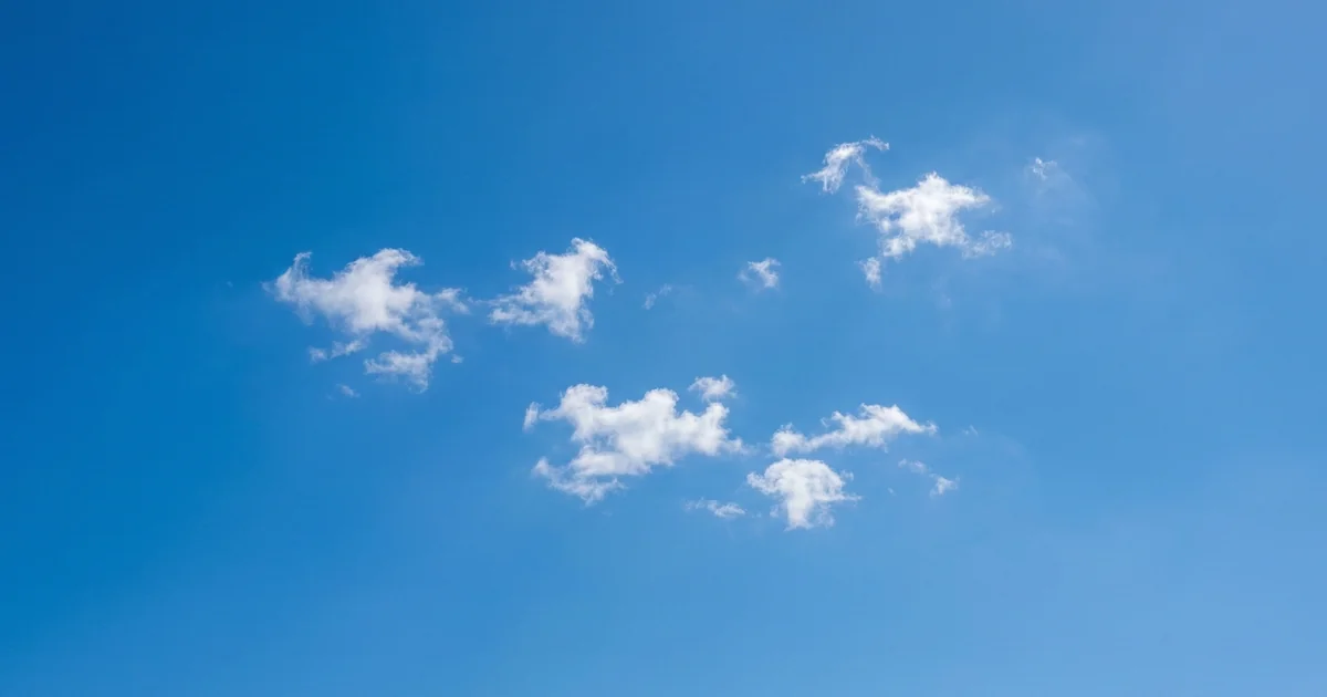 Malaga weather in June with clear blue skies and scattered white clouds, peak summer conditions on Costa del Sol