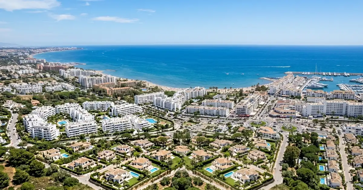 Marbella coastline with luxury villas and hillside residential neighborhoods overlooking the Mediterranean Sea.