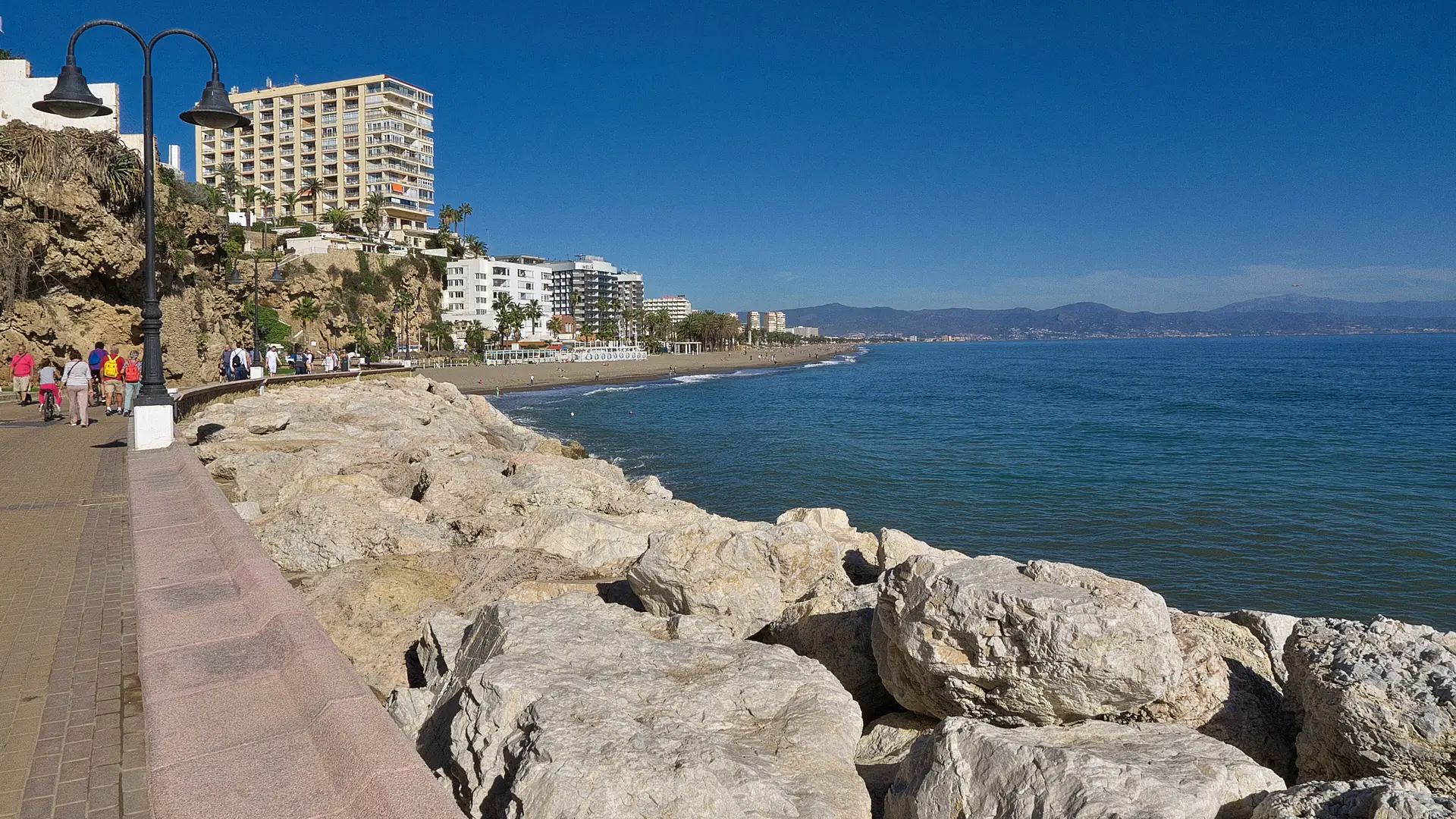 Seafront promenade and beach at El Bajondillo in Torremolinos on a clear day