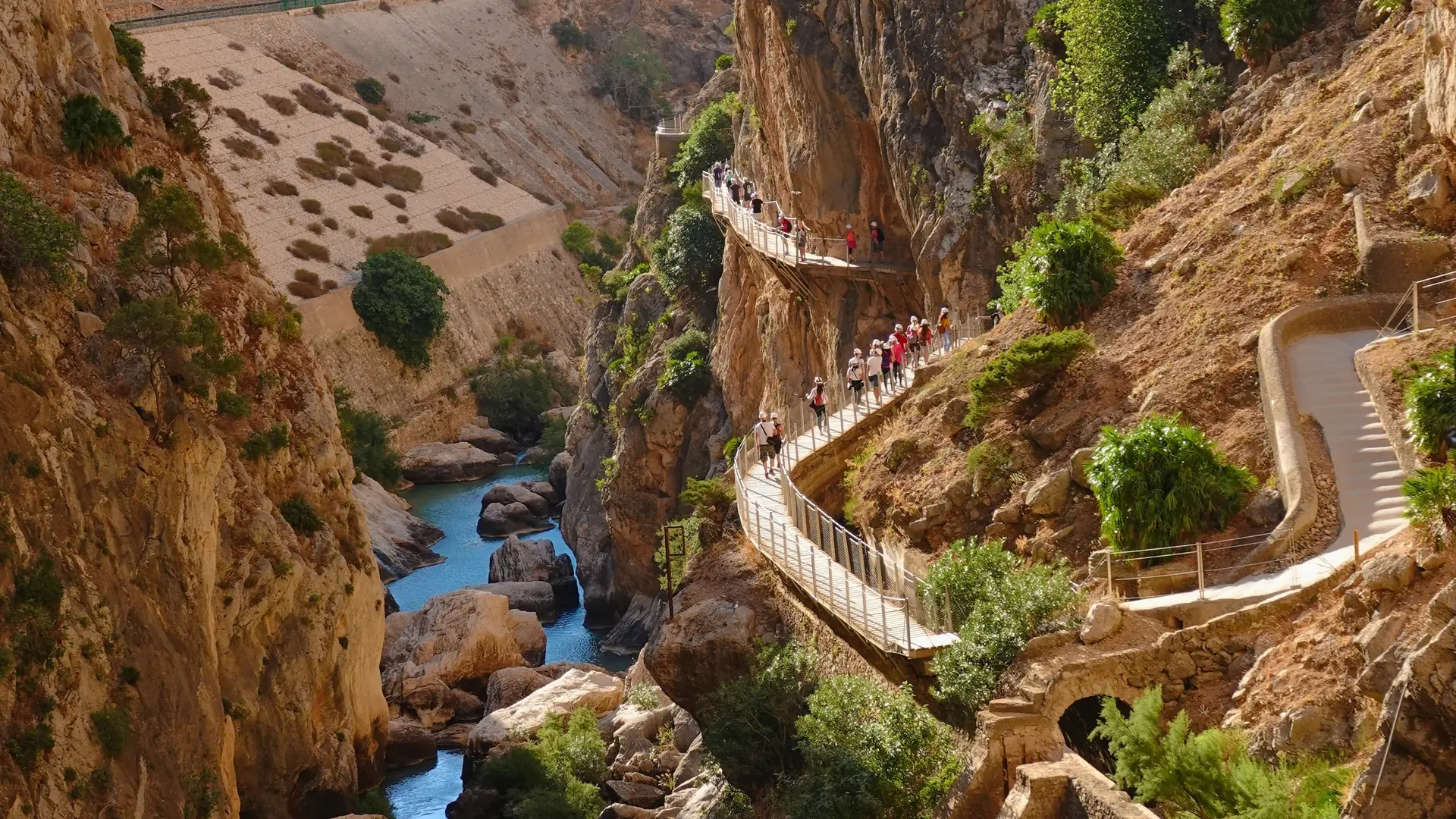 The Guadalhorce river gorge viewed from the Caminito del Rey boardwalk, with turquoise water and sheer limestone cliffs