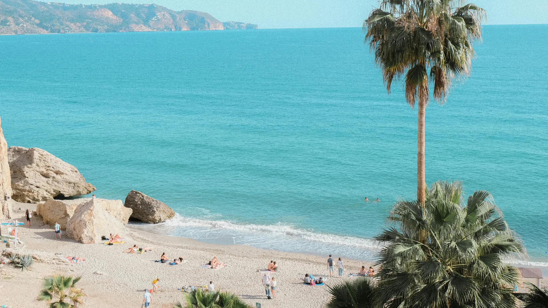 Aerial view of a Costa del Sol beach with clear blue water and golden sand