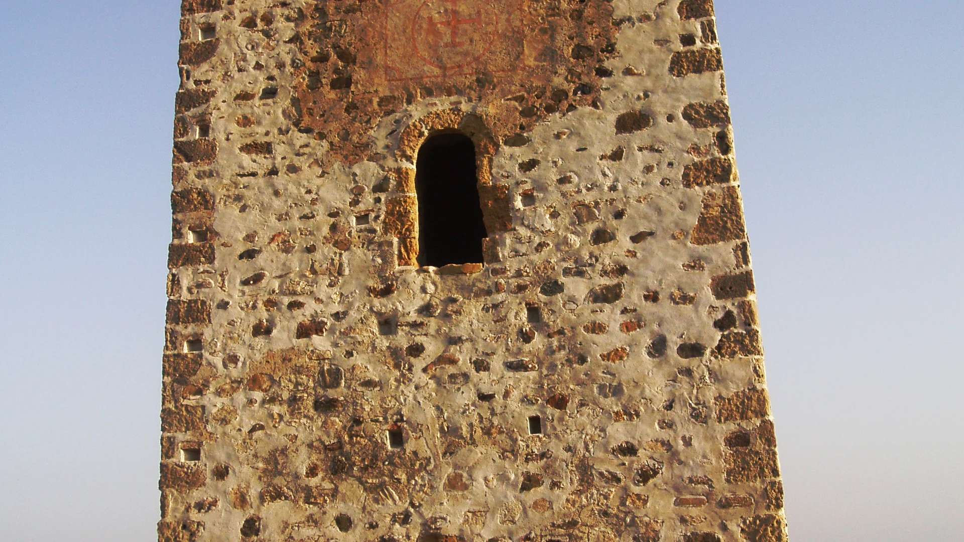The historic Torre de Guadalmansa watchtower on Estepona's New Golden Mile, with the sea behind