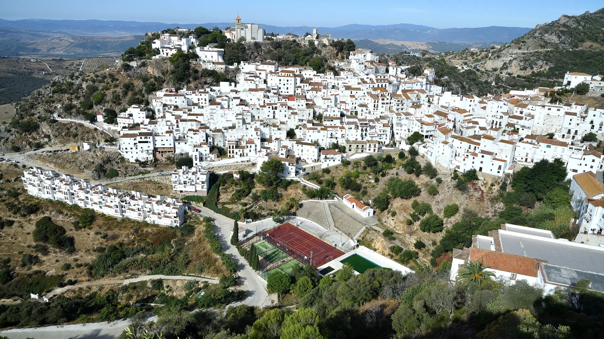 The whitewashed hilltop village of Casares above the Costa del Sol, with mountains behind