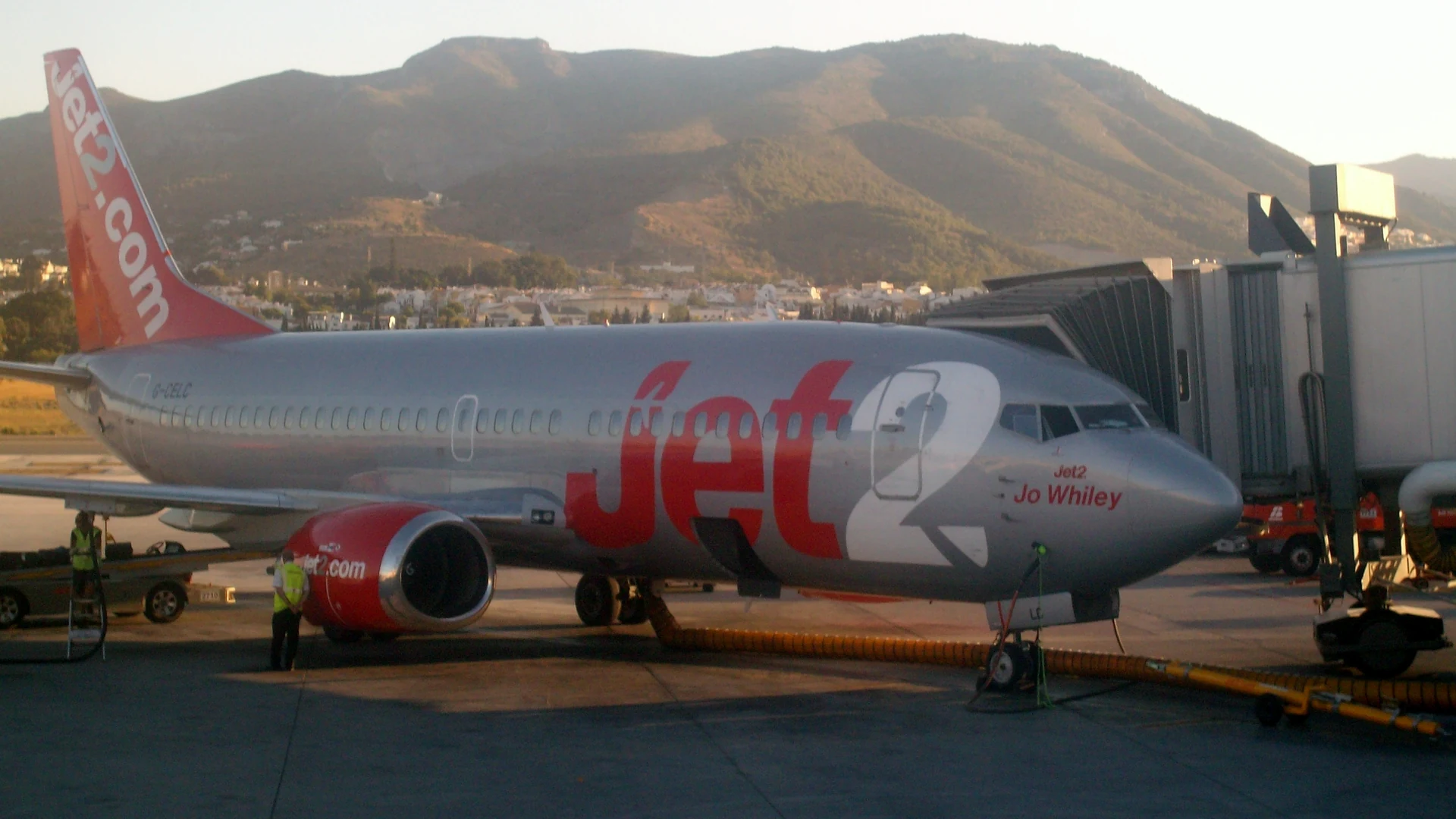 A Jet2 Boeing 737 on stand at Malaga Airport with the Andalusian hills behind it