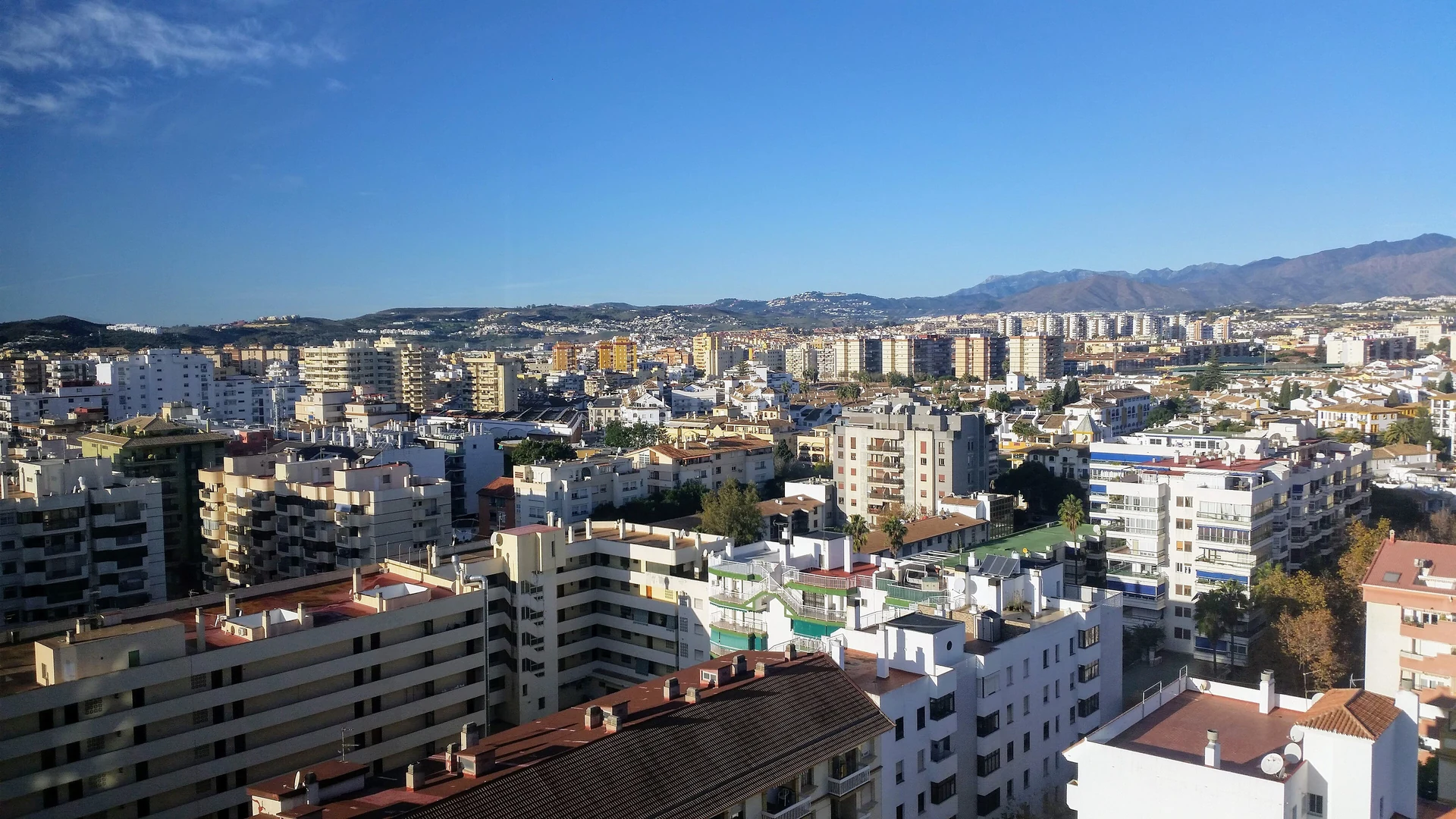 High-rise hotels and apartment blocks across Fuengirola with the mountains behind