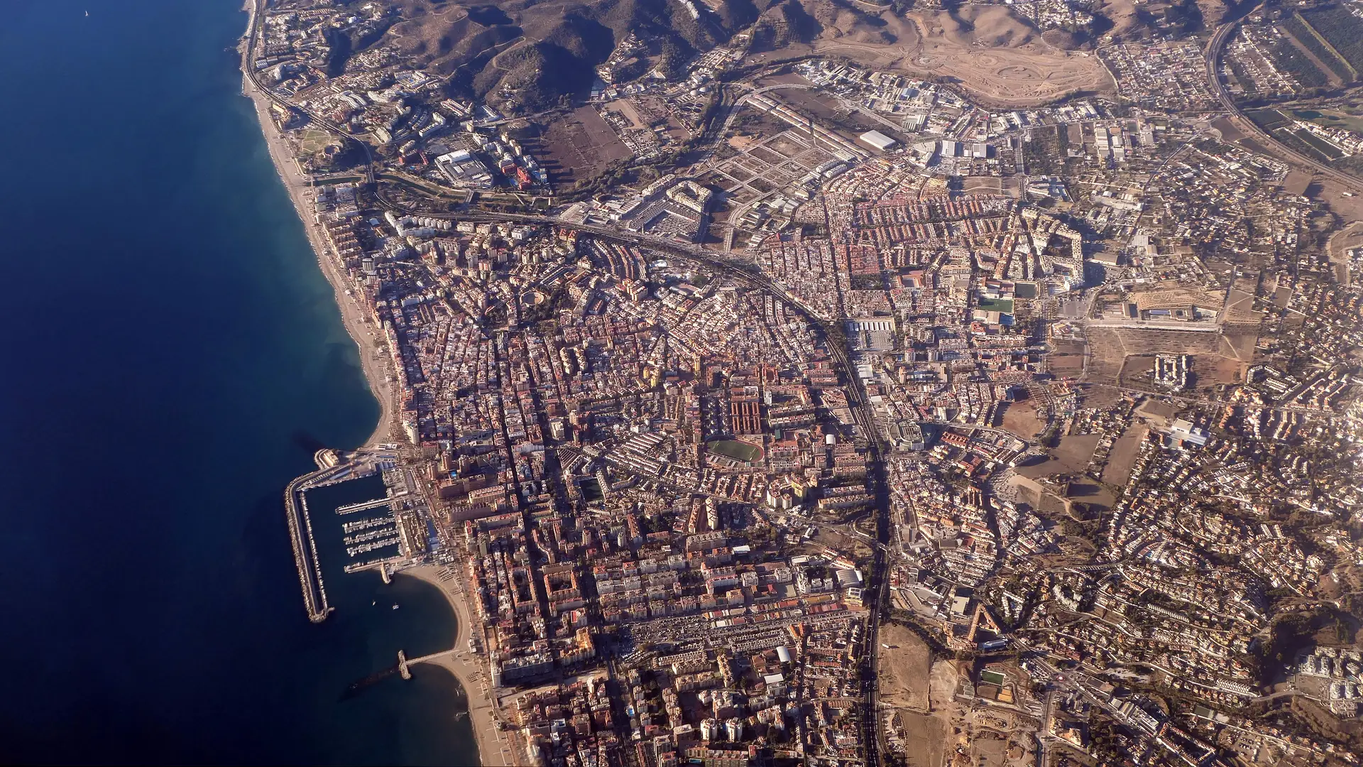 Aerial view of Fuengirola's seafront and town along the Costa del Sol coastline