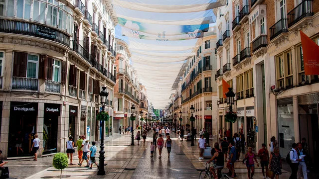 Sun-drenched Calle Larios, Málaga's main pedestrian shopping street, shaded by canopies