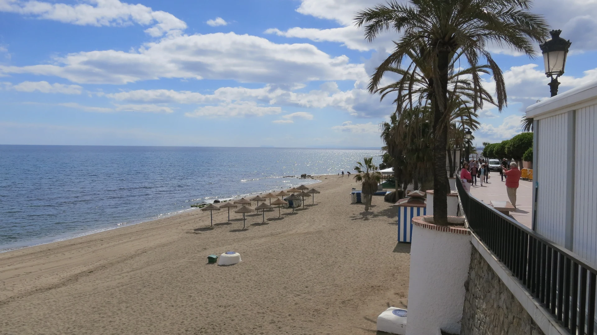 Marbella's seafront promenade and beach on a bright sunny day