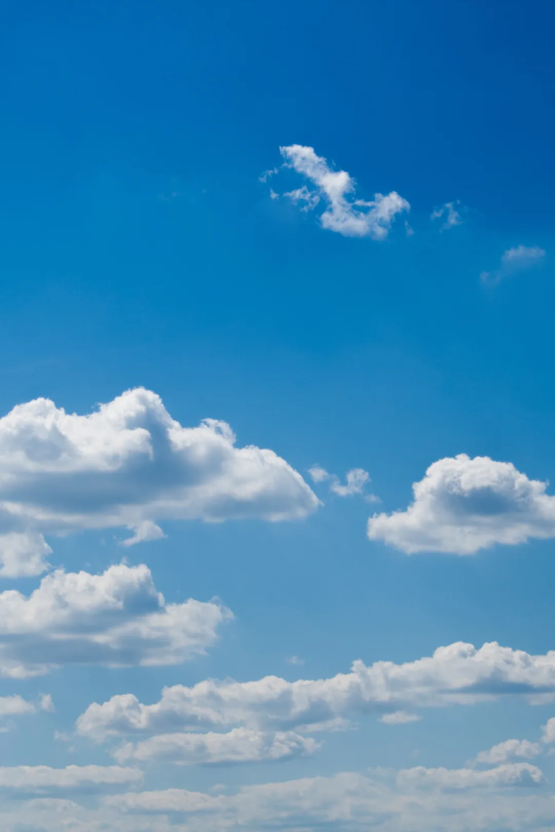 Bright blue sky in benalmadena spain with scattered white clouds.