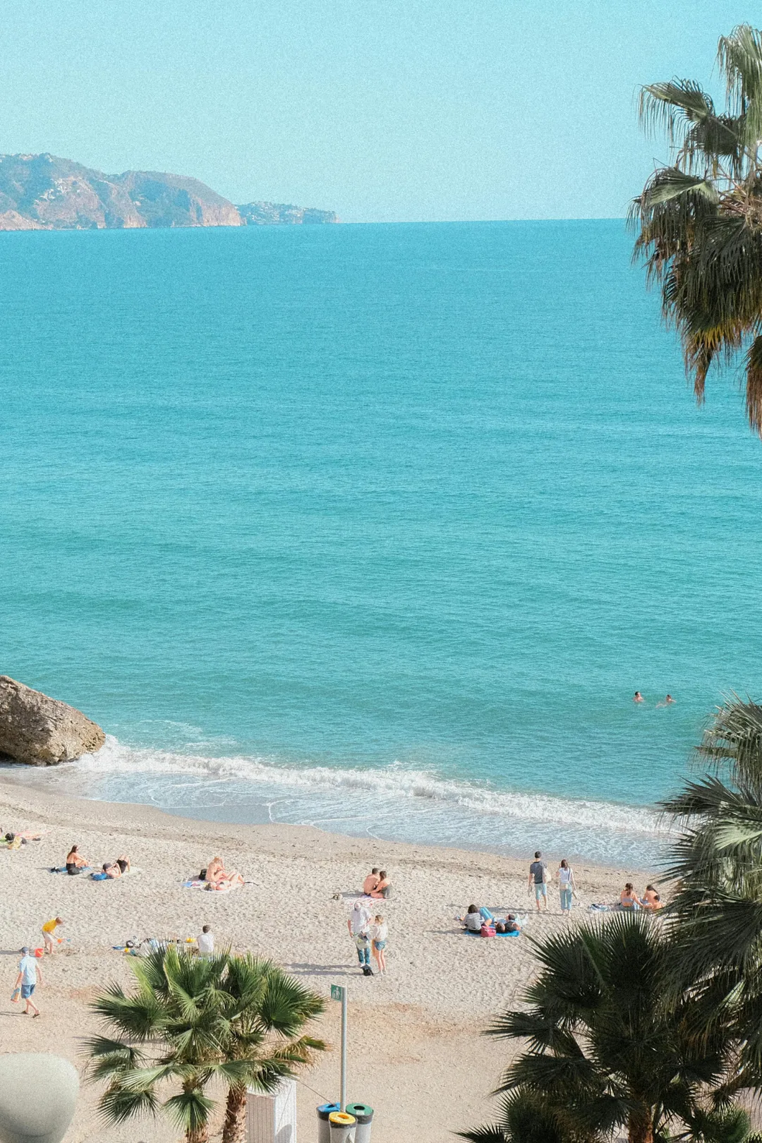 Aerial view of a Costa del Sol beach with clear blue water and golden sand