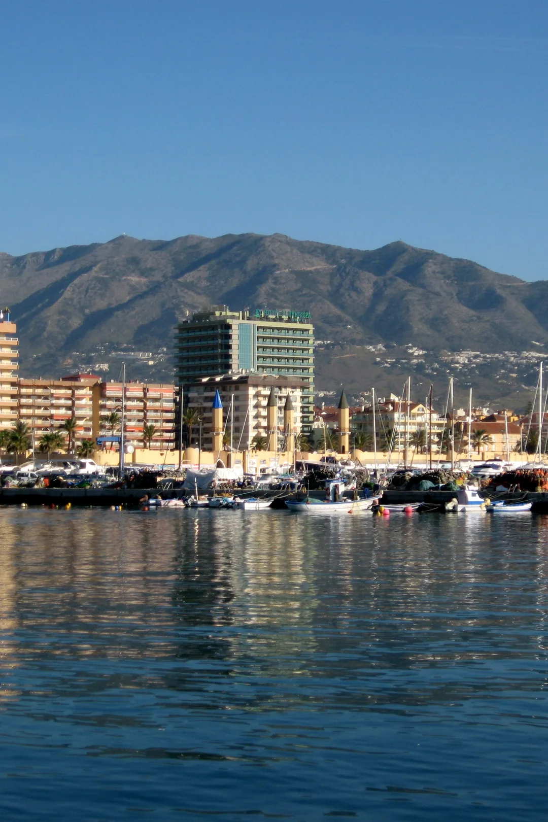 Puerto Deportivo Fuengirola marina with fishing boats and the mountains behind