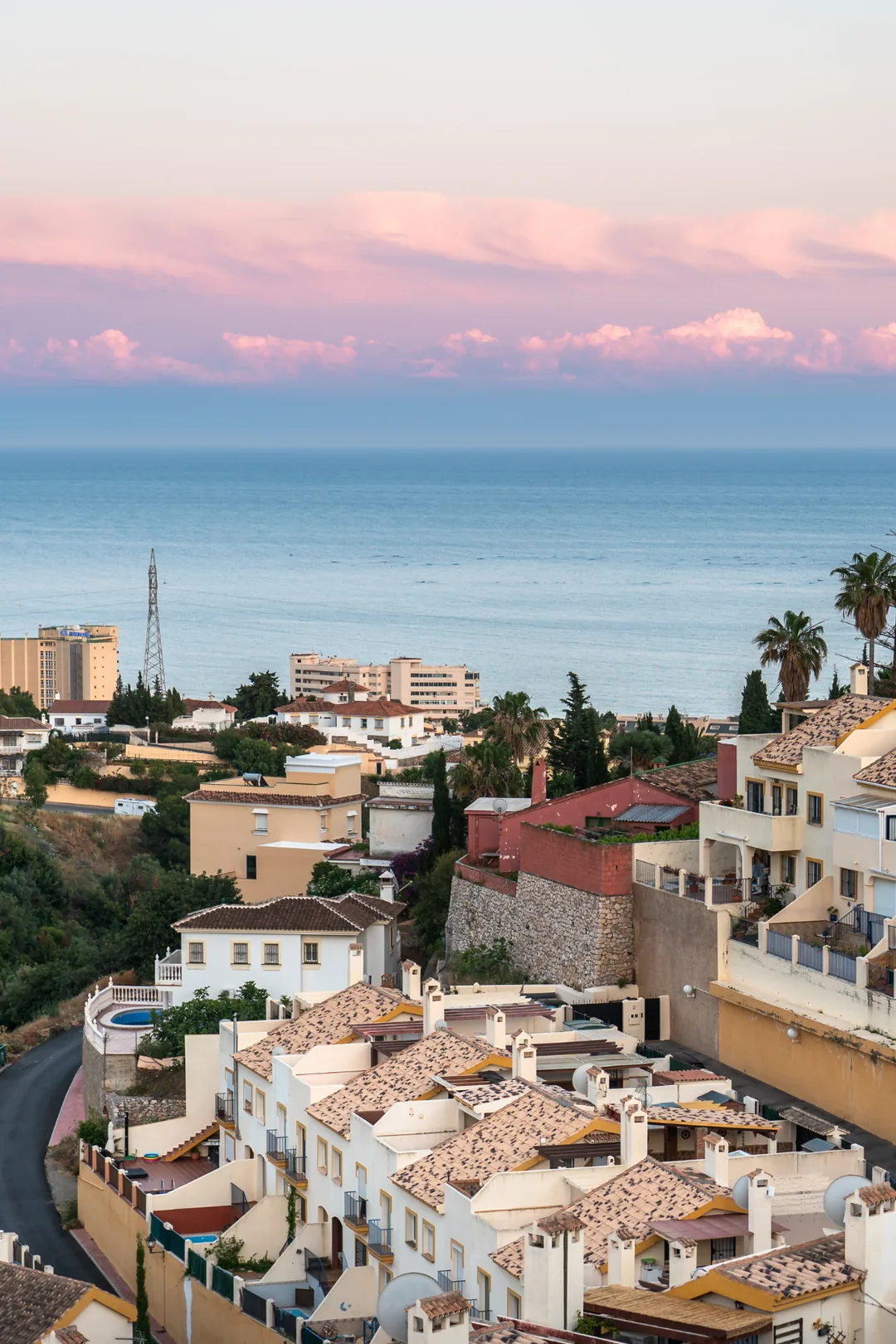 Aerial view of white Andalusian villas and hotels in Fuengirola with the Mediterranean Sea visible at sunset