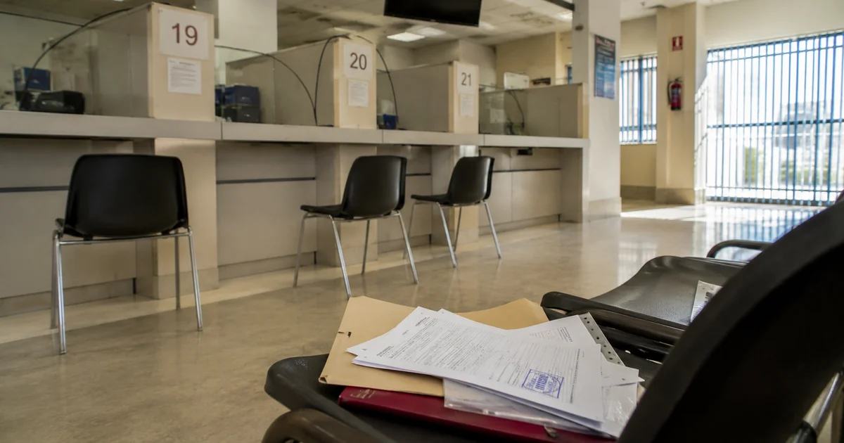 Málaga administrative office waiting area with paperwork representing NIE and TIE registration process