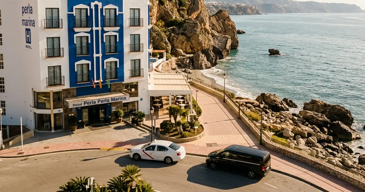 Coastal hotel arrival with sea cliffs and taxi near Perla Marina Nerja