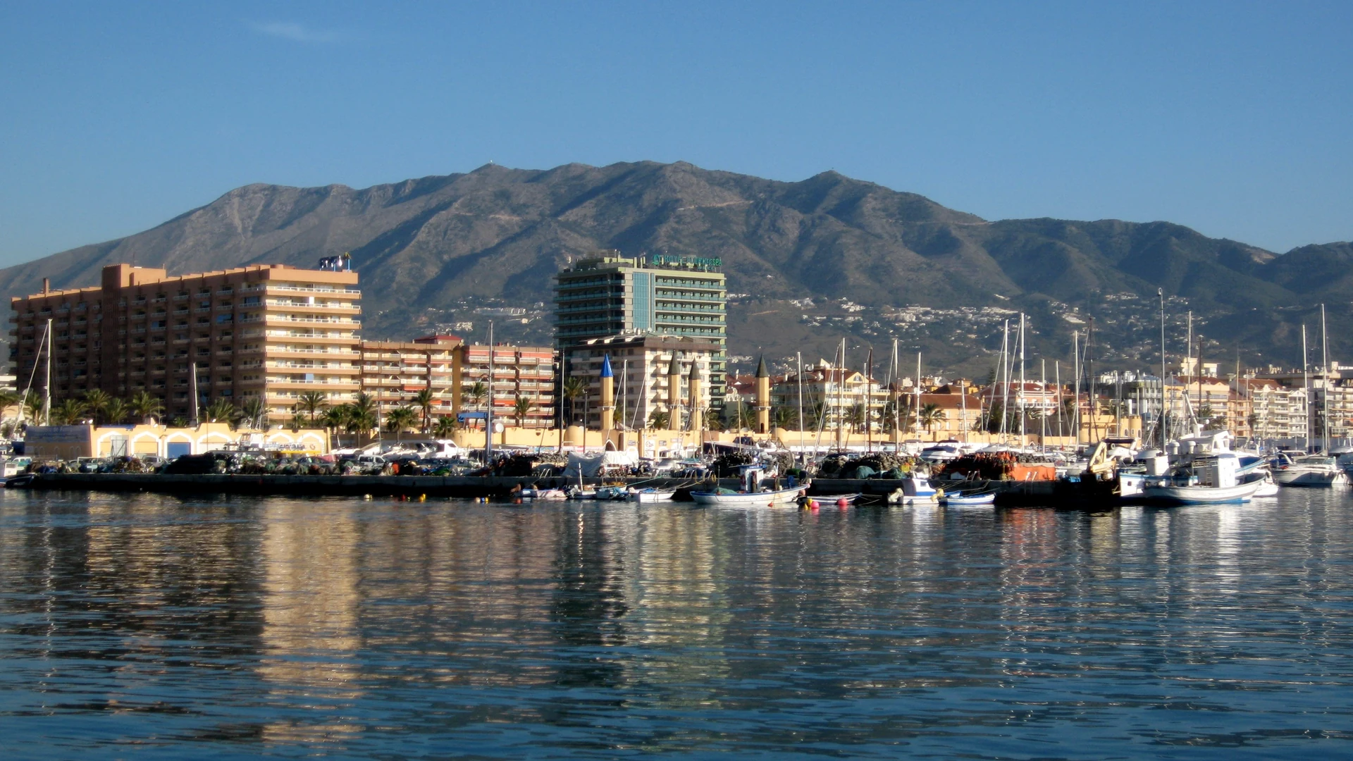 Puerto Deportivo Fuengirola marina with fishing boats and the mountains behind
