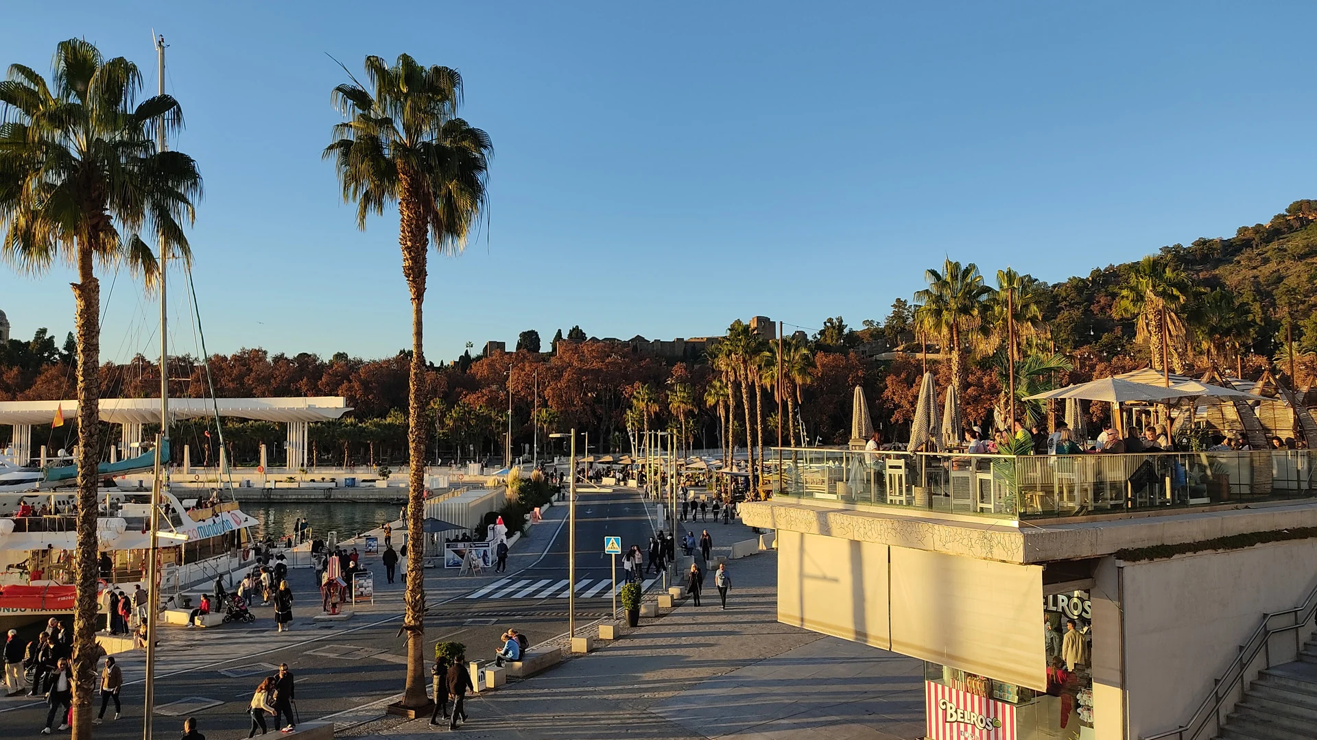 Malaga's seafront promenade at Muelle Uno, with the port and Mediterranean