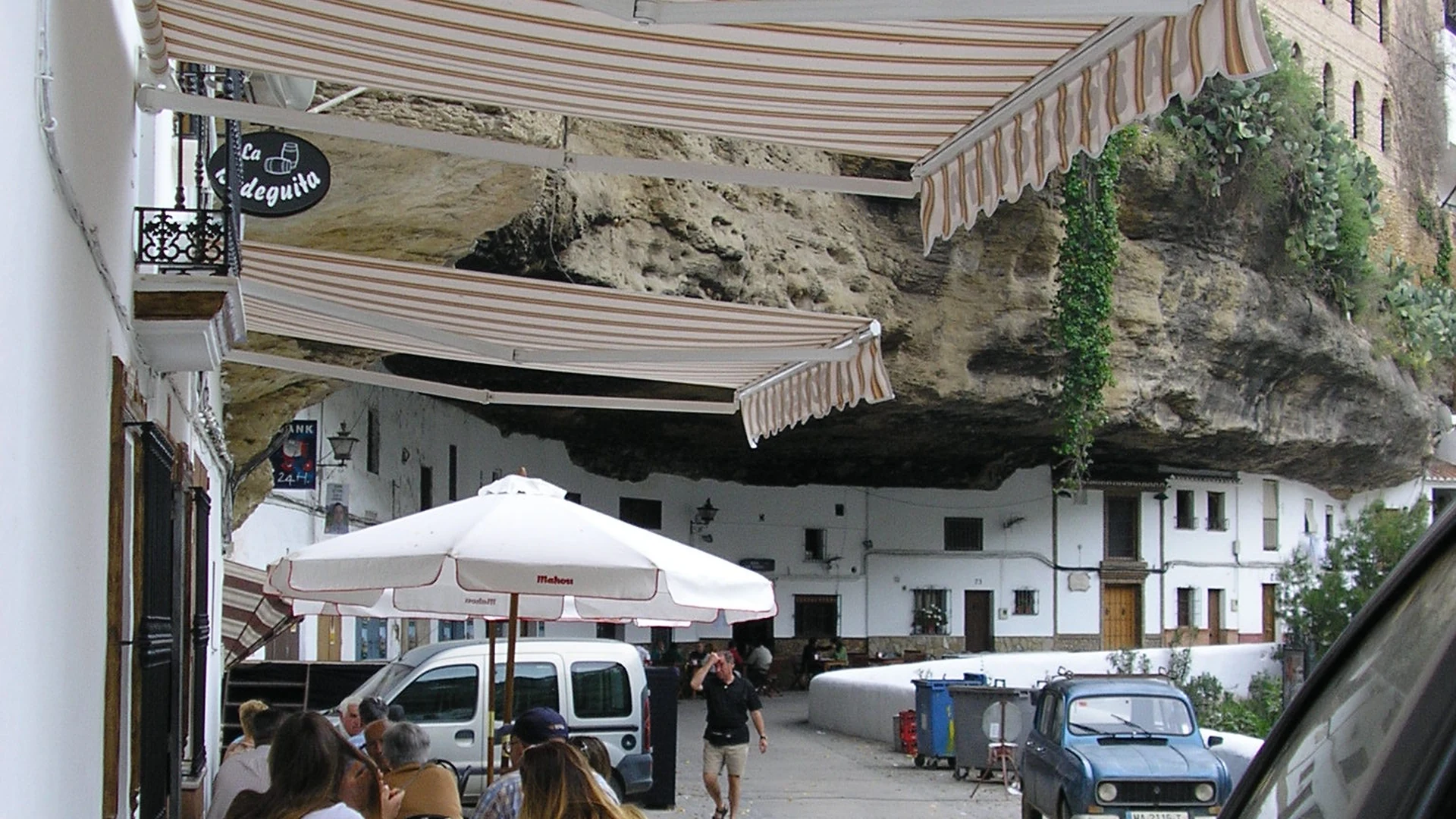 The famous Calle del Sol in Setenil de las Bodegas with whitewashed houses built under dramatic rock overhangs