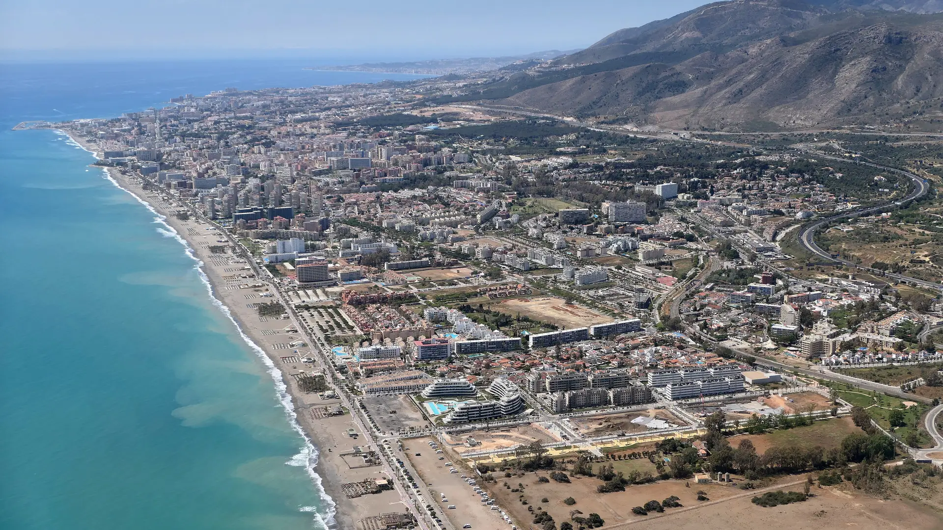 Torremolinos coastline and beach on the Costa del Sol with clear blue sky