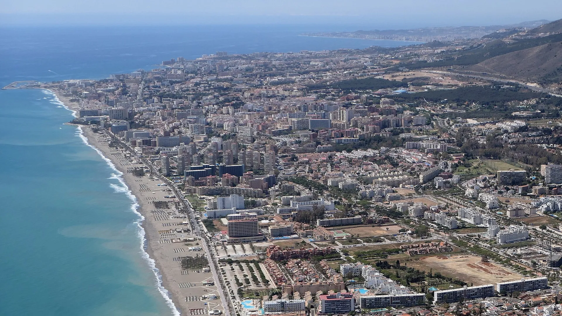 Aerial view of the Torremolinos coast with a long sandy beach and seafront buildings