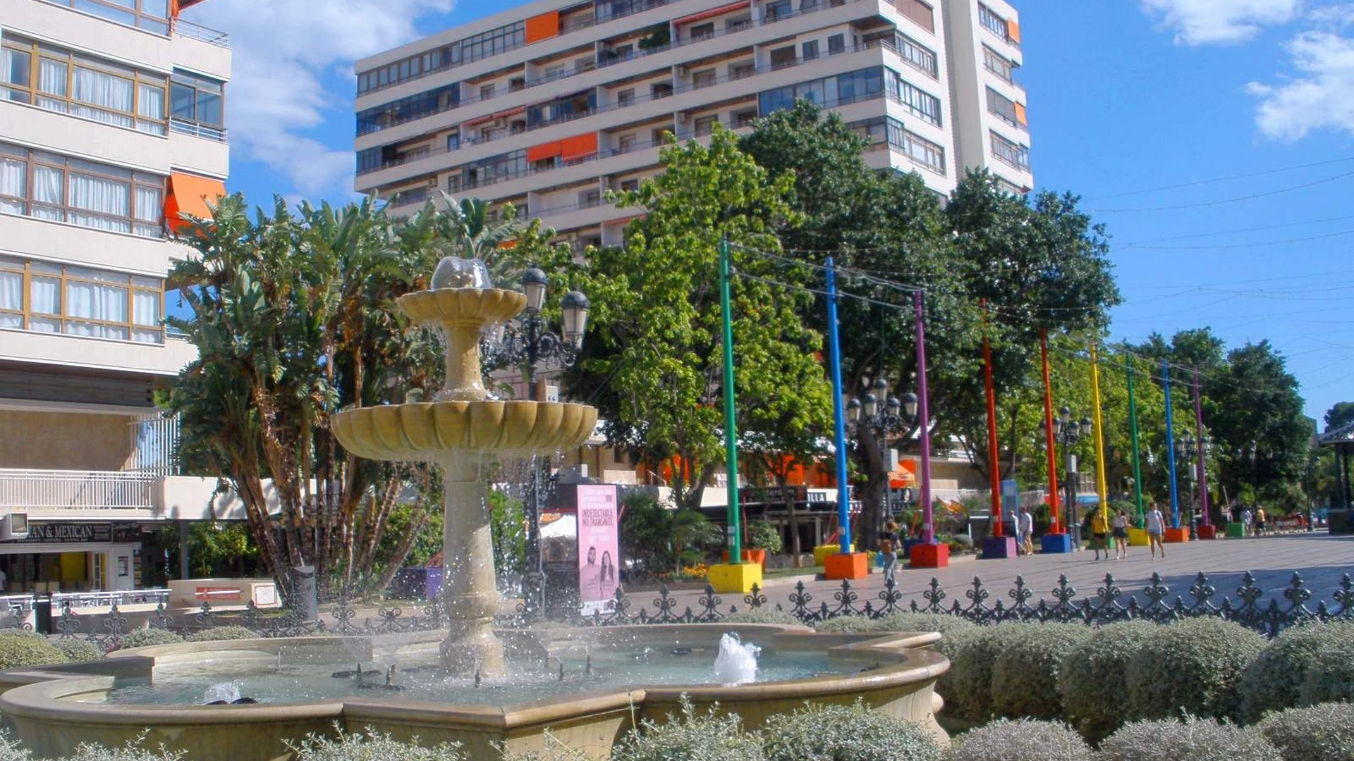 Plaza de la Nogalera in Torremolinos with a fountain and coloured poles in the pedestrian square