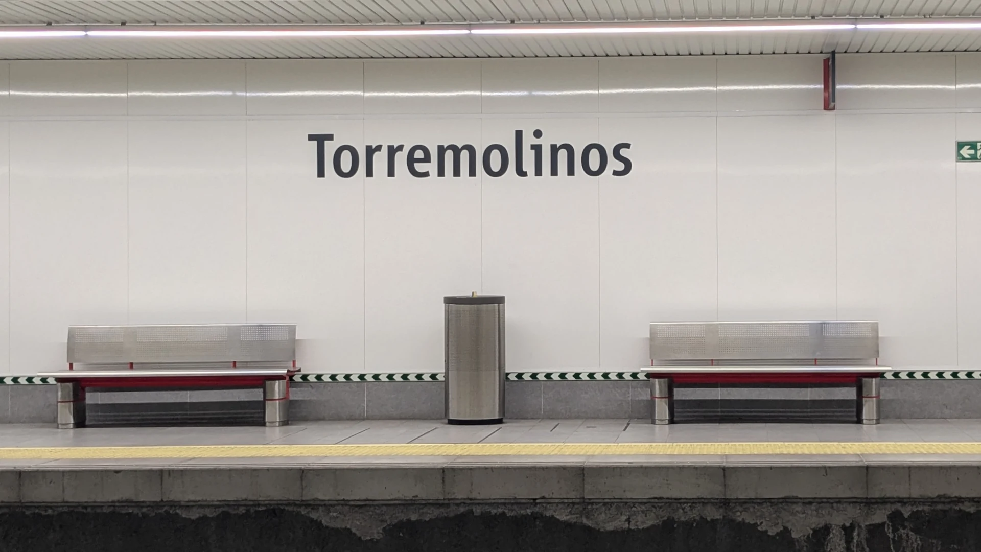 Platform at Torremolinos railway station on the Cercanías C1 line, with the station name on the wall