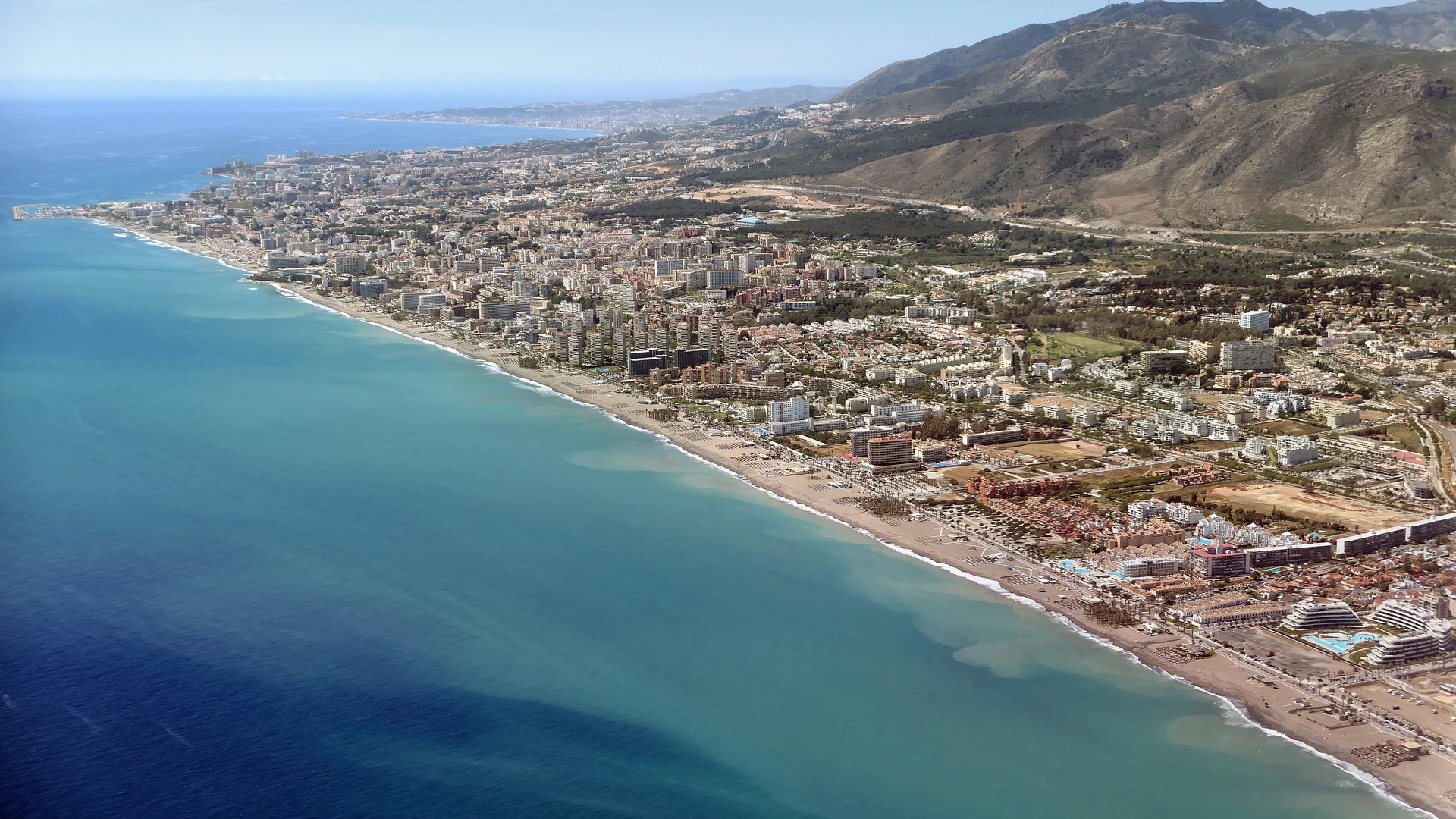 Aerial view of the Torremolinos seafront and beaches with the mountains behind