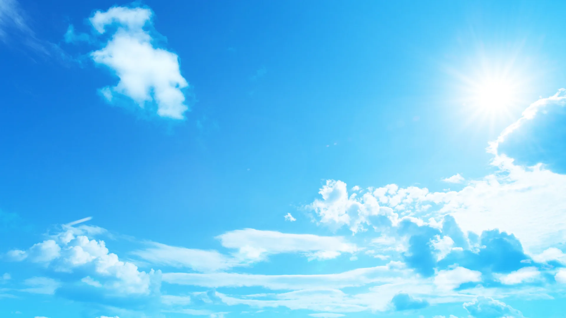 Bright blue sunny sky with scattered white clouds representing the warm and sunny weather in Fuengirola, Spain.