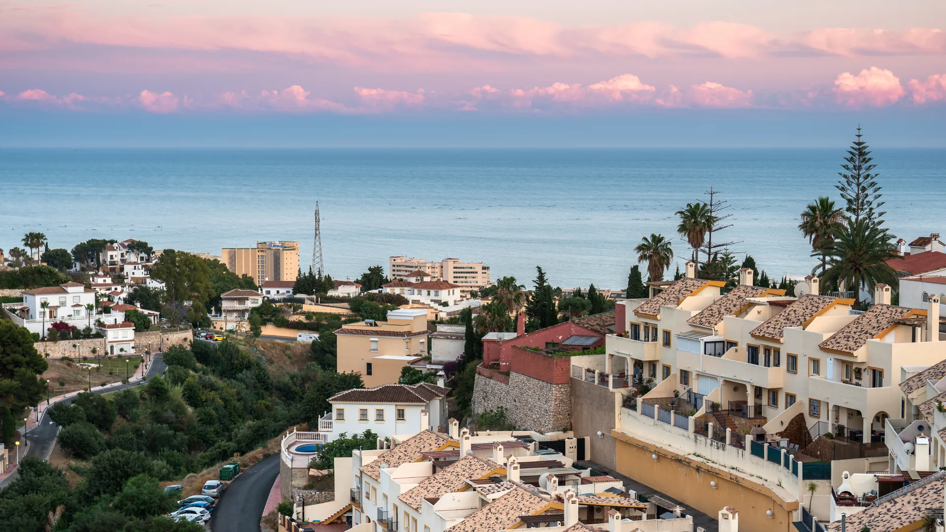 Aerial view of white Andalusian villas and hotels in Fuengirola with the Mediterranean Sea visible at sunset