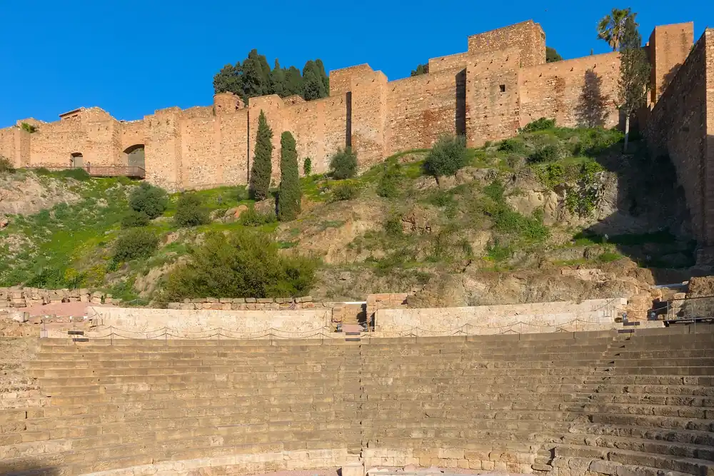 The Roman theatre of Málaga with the walls of the Alcazaba fortress rising behind