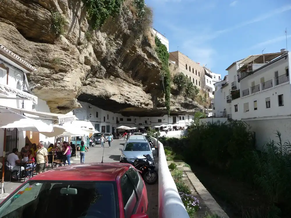 Houses and cafés of Setenil de las Bodegas built directly under a huge rock overhang